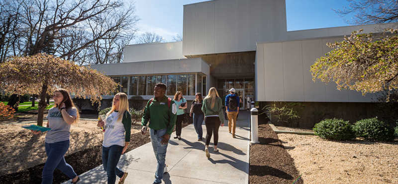 James F. Lincoln Library. Photograph of students walking out of the LEC Library.