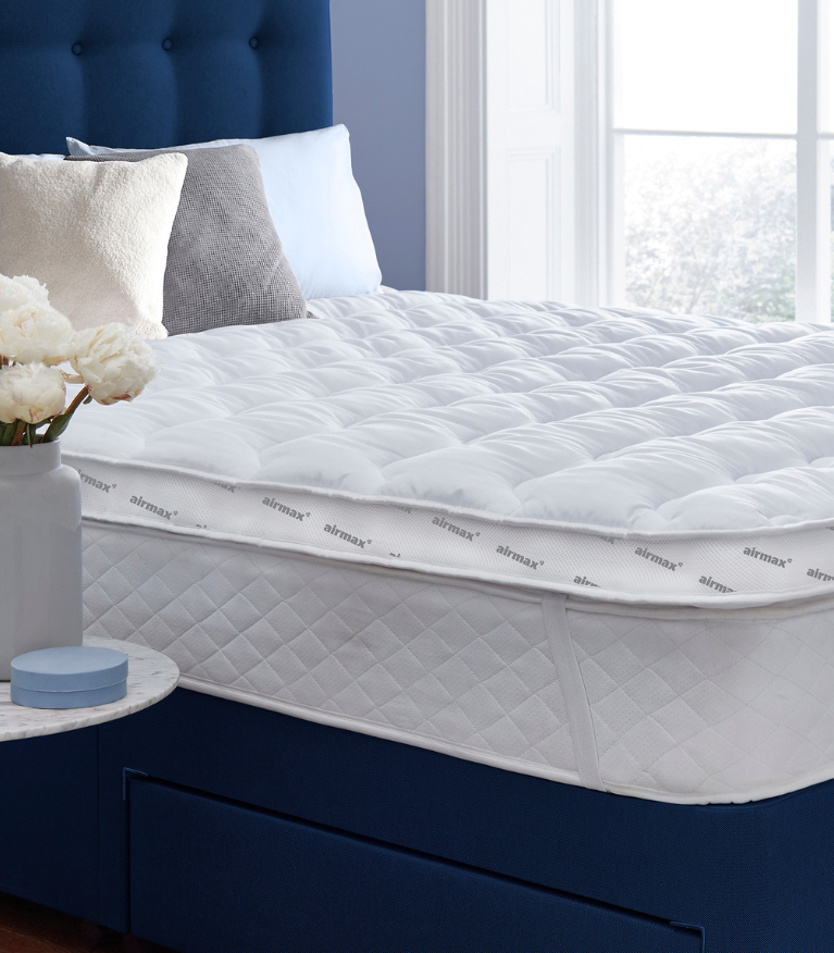 topper on a blue bed