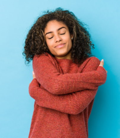 person hugging themselves for self care day