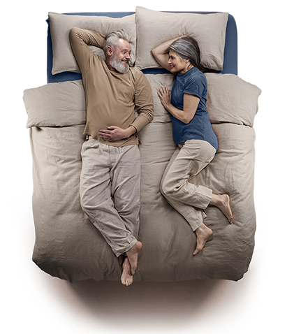 Top down view of a senior couple laying on a Silentnight naturals bed.