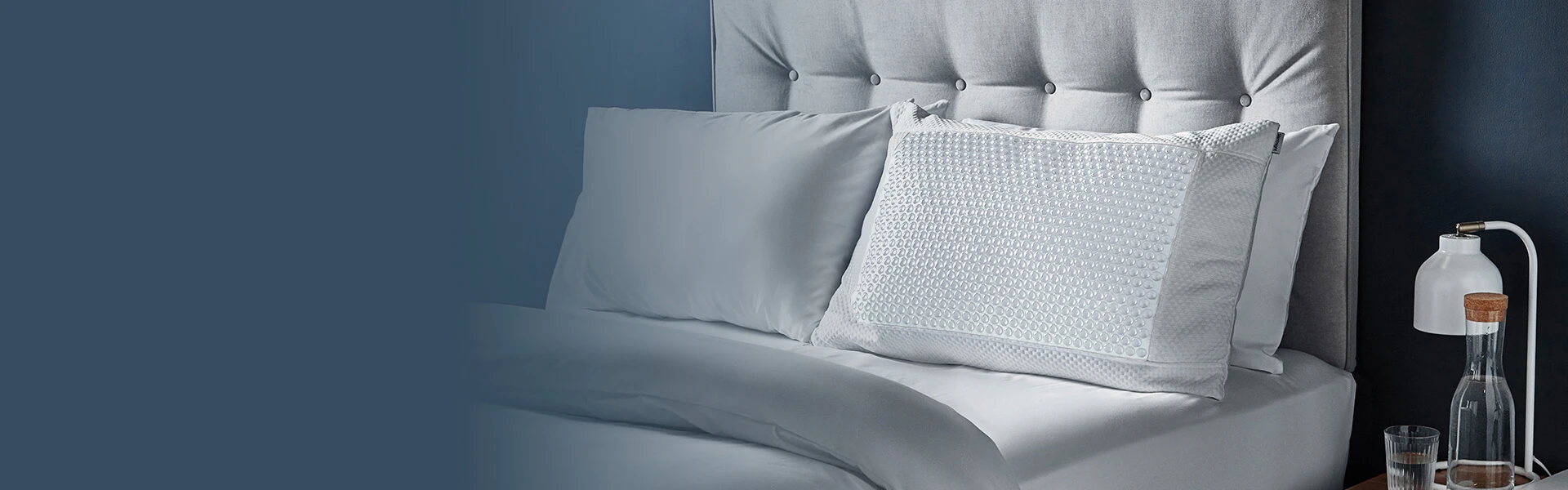 Cool gel pillow on bed with set of pillows