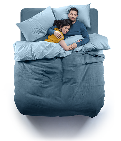Top down view of a couple sleeping in a Silentnight Geltex bed. Blue