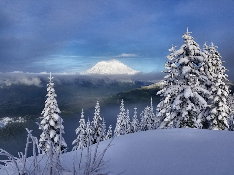 Mount Rainier peeking out of clouds. Views of Mount Rainier from High Hut.
