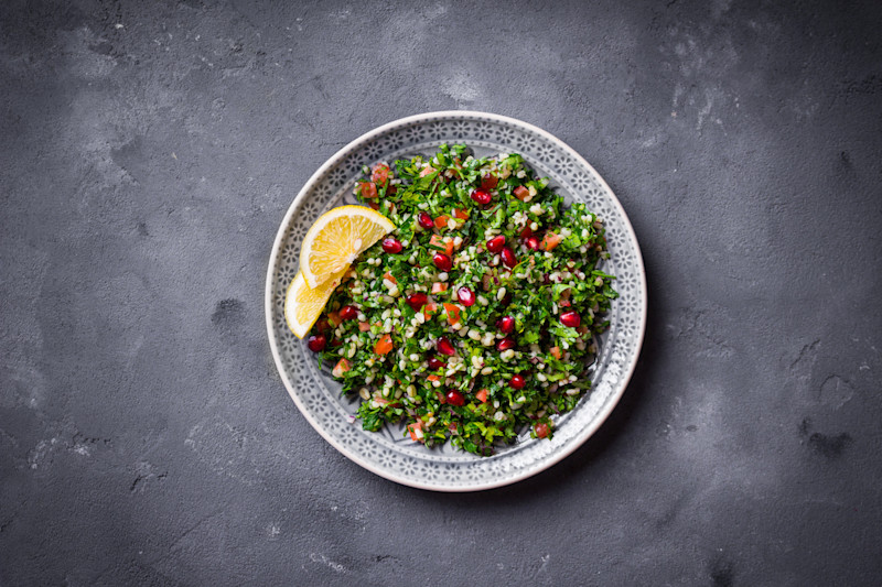 Tabbouleh salad on plate with lemon