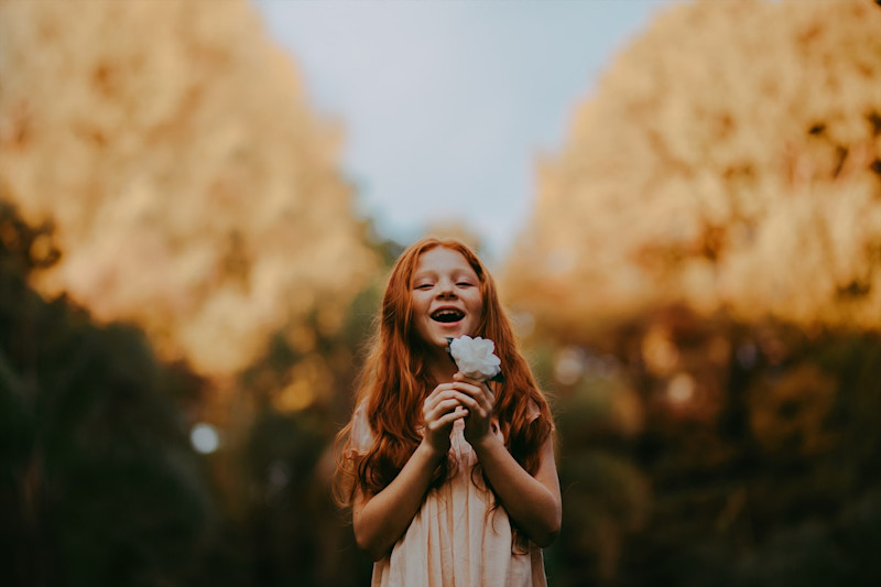 portrait photo of child with flower