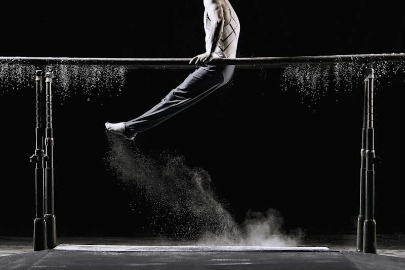 man on parallel bars in gymnastics