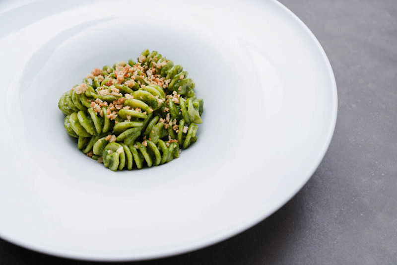Massimo's pasta with pesto upclose on white plate