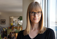 a person with glasses smiling