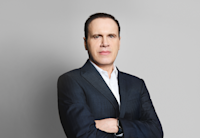 A headshot of Paulo Lemgruber. He's wearing a dark suit and white shirt.