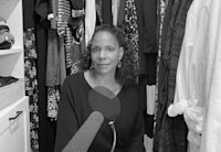 Actress Audra McDonald sits in her walk-in closet, a microphone propped in front of her, the clothes hanging around her helping to dampen the sound. Photo credit: Devin Oktar Yalkin/New York Times