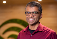 A headshot of Ian Moraes, who's smiling. He's wearing glasses and a red shirt.