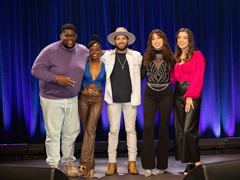 a group of "Breakthrough" contestants standing together on a stage