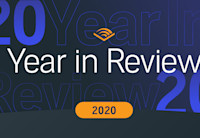 The words Year in Review appear in white against a dark blue background. The year, 2020, appears below it in an orange bubble as well as in faded text in the background of the image. Audible's chevron logo appears in orange at the top of the image.