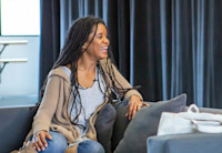 Proof of Love playwright and Newark native Chisa Hutchinson sits on a couch at her play's rehearsal.