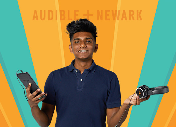 A high school student in a blue polo shirt stands with a tablet in one hand and a pair of headphones in the other. Audible + Newark is displayed behind him.