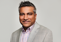 A photo of Pat Shah, who's wearing a grey blazer and plaid shirt.