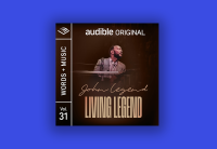 The cover art for John Legend's Audible Original "Living Legend" is on a bright blue background. The Cover has a photograph of John Legend playing piano. 