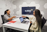 Two women meet in an Audible conference.