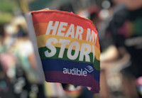 The Audible Pride flag is raised proudly at the World Pride March in NYC.