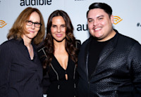 Directo Jo Bonney, actress Kate del Castillo and playwright Issac Gomez pose together in front of an Audible backdrop.