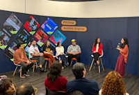 Mikaela Pasa pitches her team’s winning project to judges Leo Neumann, Chico Felitti, Paula Scarpin, Bianca Comparato and MM Izidoro, as Audible’s country manager for Brazil Adriana Alcântara looks on.