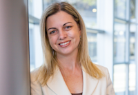 woman leaning on a column in a lobby