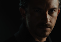 A still from the trailer for the English-language edition of "Dracula." Playing Count Dracula, actor Jonathan Bailey stares ominously at the camera from the shadows.