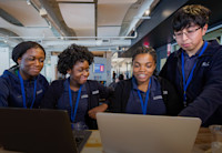 Edna Agyemang, Newark high school intern, working at Audible with her fellow interns.