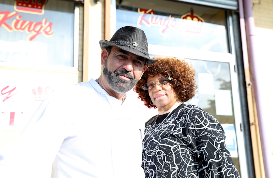 Ali and Tina Darweesh pose in front of a restaurant.