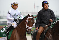 Audible the horse with his jockey on his back. A rider on a companion horse are leading them.