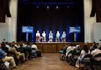 A panel of Audible employees speaks from the stage at the Innovation Cathedral to an audience.