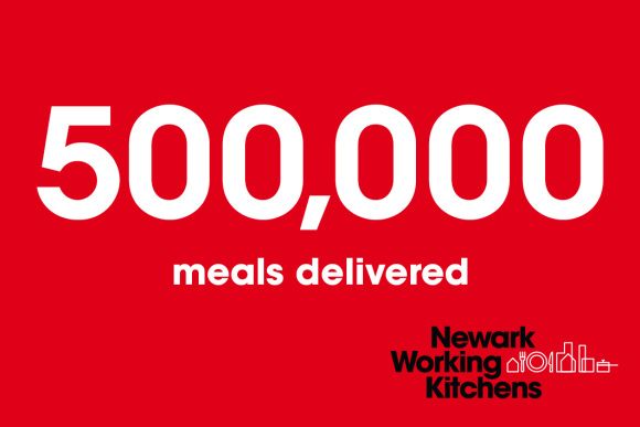 Against a red background, white text calls out 500,000 meals delivered below the Newark Working Kitchens logo.