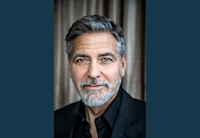 A headshot photo of actor, producer, and director George Clooney. He is looking directly at the camera.