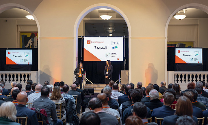 Two founders on stage at Newark Venture Partners Demo Day showcasing their tech start-up in front of an audience.