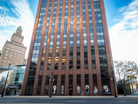 a tall building with persony windows and collages of women