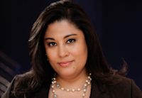 a person with long hair wearing a pearl necklace