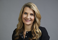 A headshot of Aurelie de Troyer. She has blonde hair and is wearing a black shirt. She's smiling.