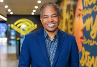 A photo of Derek Murphy, who's smiling and wearing a blue blazer and shirt.