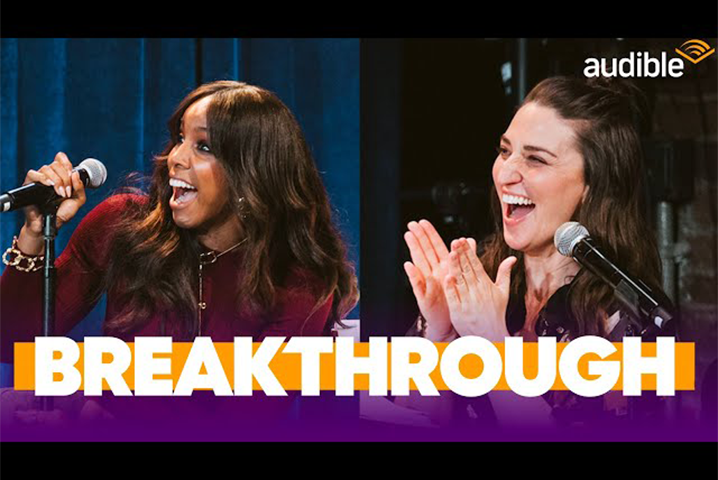 Kelly Rowland and Sara Bareilles talking into a microphone
