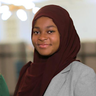 An Audible high school intern stands in the office.