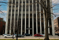 A generated photo of a commercial building in Newark with cars parked in front of it.