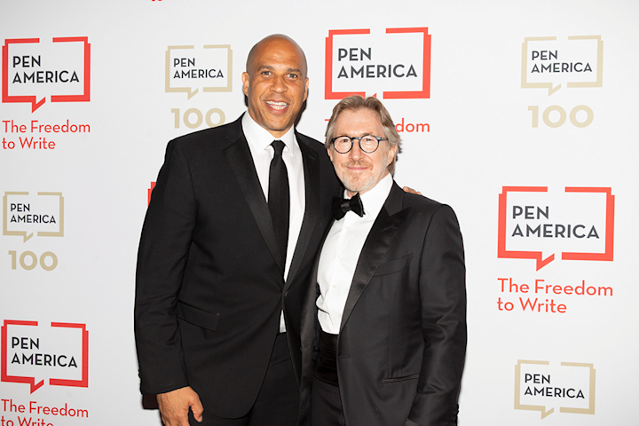 Audible founder and Executive Chairman Don Katz stands on the red carpet at the PEN America gala with Senator Cory Booker. Katz is wearing a tuxedo. Booker is wearing a black suit and tie. Behind them, the backdrop is white with the PEN America logo repeating across it with the tagline, "The Freedom to Write."
