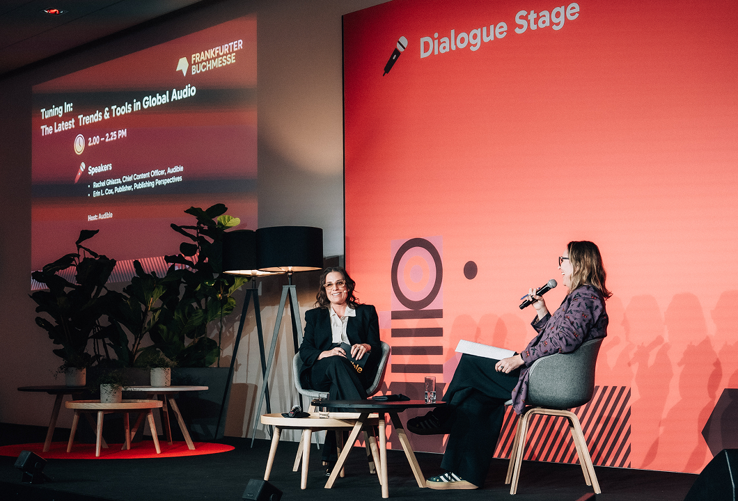 Audible's Chief Content Officer, Rachel Ghiazza, is seated onstage for her panel at Frankfurt Book Fair. On her left is Erin Cox of "Publishing Perspectives," who's moderating.
