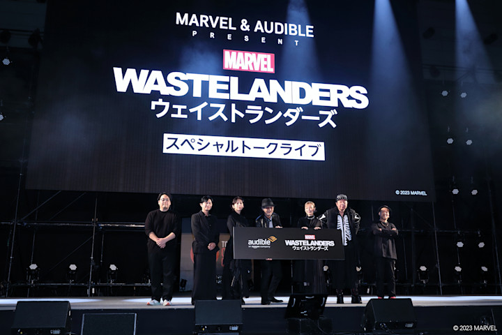 a group of celebrities standing on a stage