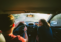 A photo of two people in a car.