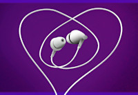 White earphones against a purple background. The earphones cord is looped in a heart shape.