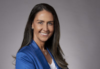 A headshot of Adriana Alcântara.