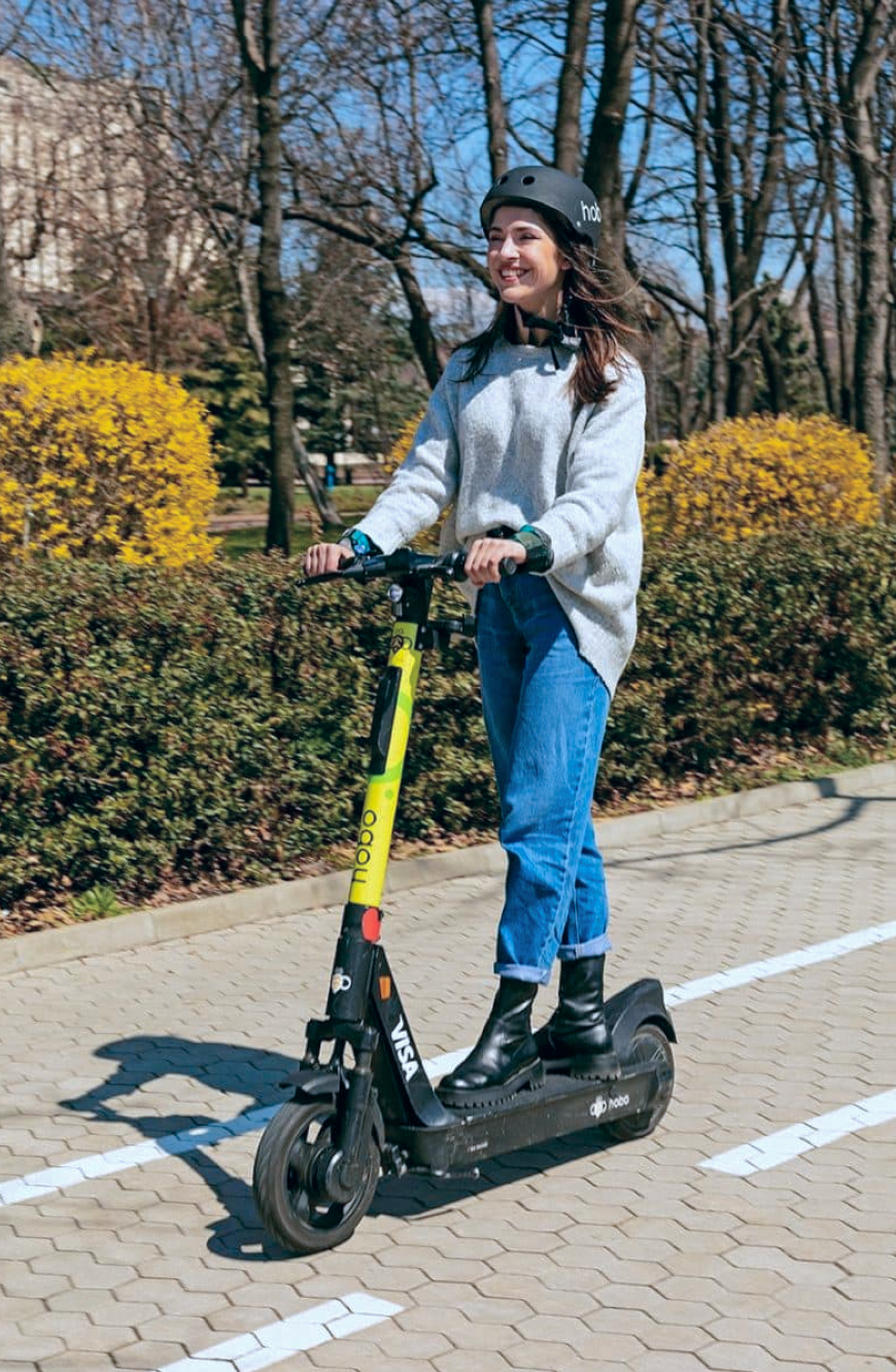 Hobo cover image featuring caucasian female driving on a kickscooter.