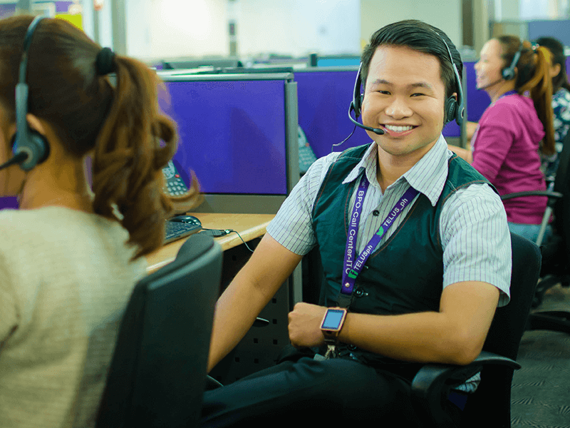 TELUS International team member sitting in the call center