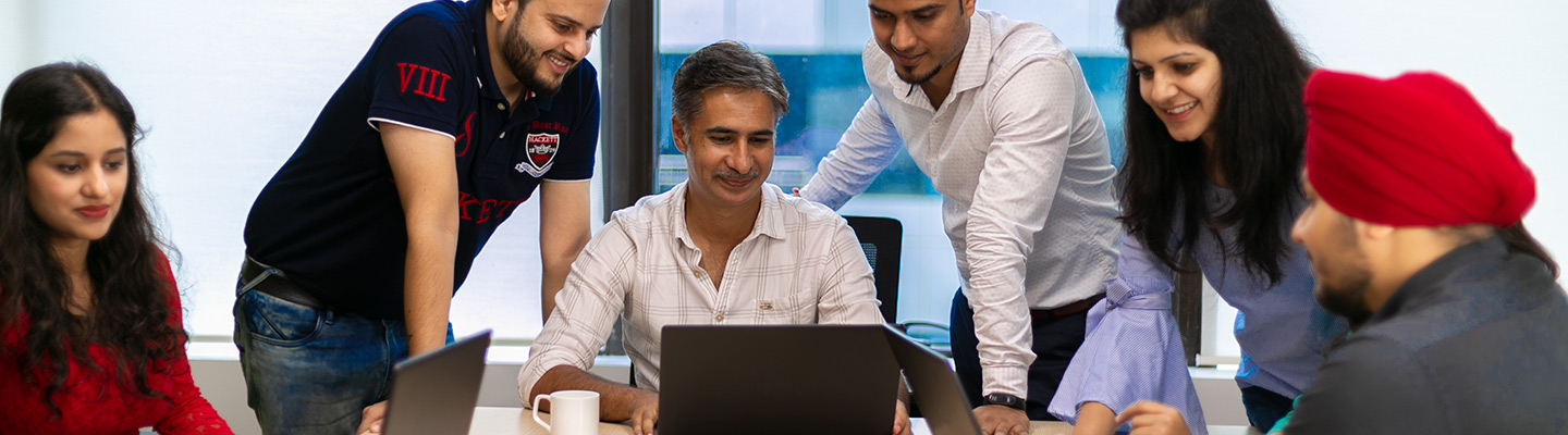 Employees looking at a laptop